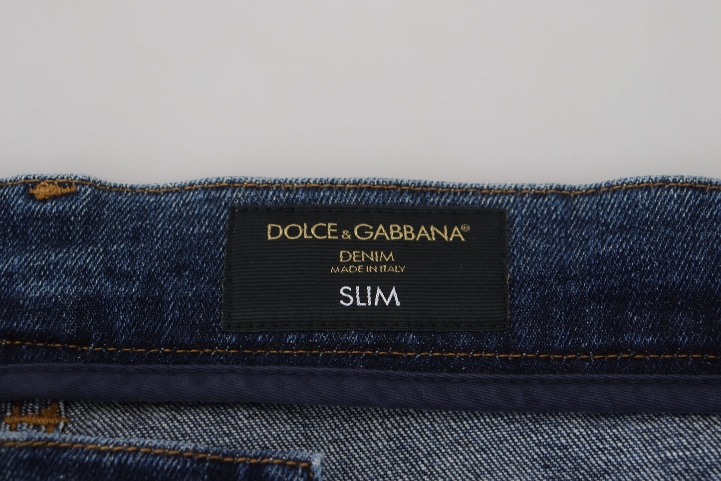 Jeans slim in denim stretch di cotone blu stracciato