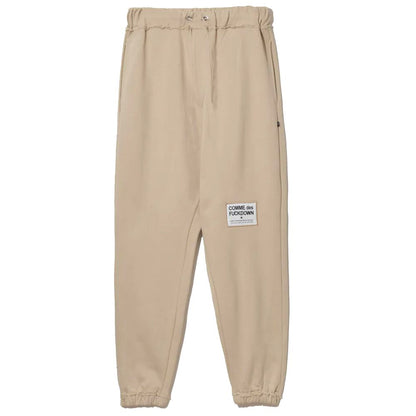 Comme Des Fuckdown – Schicke Jogginghose aus Baumwolle in Beige mit ausgefransten Details